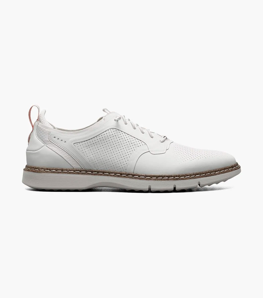 The Stacy Adams SYNCHRO Plain Toe Elastic Lace Up - White - 25518-100 is a versatile shoe showcasing white perforated leather with elastic laces, a brown sole, and a red pull tab at the heel. Crafted by STACY ADAMS for comfort, it offers anatomical arch support, making it ideal for any occasion.