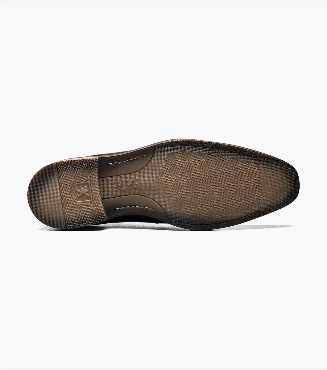 The Stacy Adams - JOVIAN Plain Toe Laser Oxford in black, product code 25504-001, is a premium dress shoe boasting a lace-up closure and distinctive brown detailing on the sole. Made from laser-treated leather for a sleek finish, it includes a Memory Foam insole to enhance comfort.