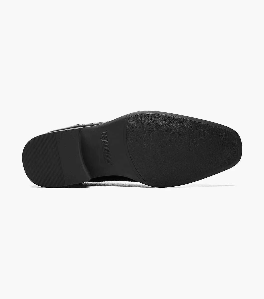 The Stacy Adams WAKEFIELD Bike Toe Bit Slip On in black is a sleekly designed leather men's dress shoe with a metallic decorative strap across the top and a cushioned footbed for added comfort. This perfectly crafted slip-on style offers easy wear.