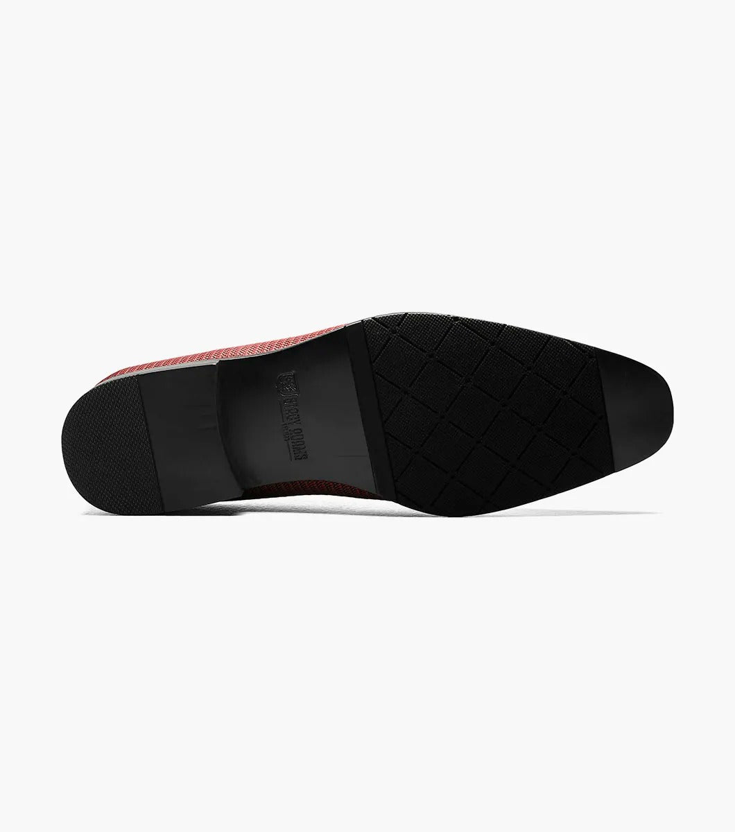 Introducing the Stacy Adams - Tazewell Plain Toe Tassel Slip On in Brick, characterized by its red textured design, black trim, and tassels on top. It features a fully cushioned footbed for ultimate comfort.