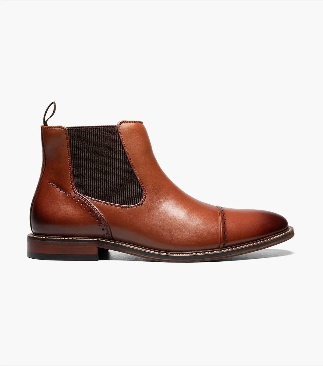 The Stacy Adams MAURY Cap Toe Chelsea Boot in Cognac features ergonomic elastic side panels, anatomical arch support, and a convenient pull tab on the heel.