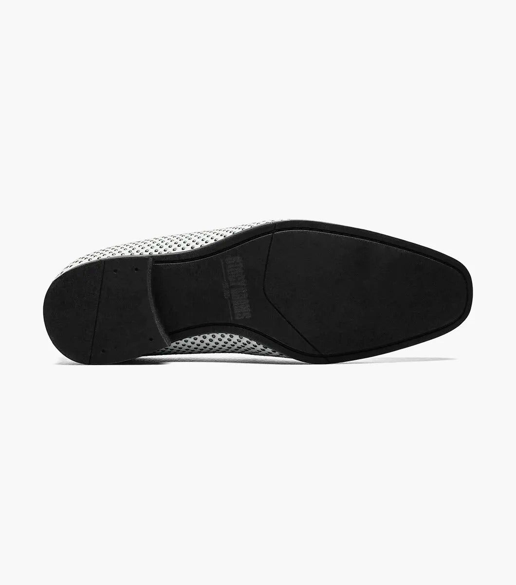 The Stacy Adams - SWAGGER Studded Slip On (Black with White, 25228-111) showcases a striking design with a white studded leather loafer contrasted by a black sole and adorned with a decorative metal emblem on top, offering both style and comfort thanks to its Memory Foam insole.