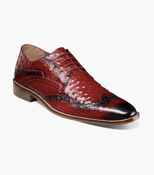 The Stacy Adams GENNARO Wingtip Oxford in red (model 25537-600) showcases an exquisite design. With its genuine leather outsole and elegant brogue features, this sophisticated dress shoe offers a textured surface with decorative perforations, a lace-up closure, and a low heel for those who appreciate timeless style.