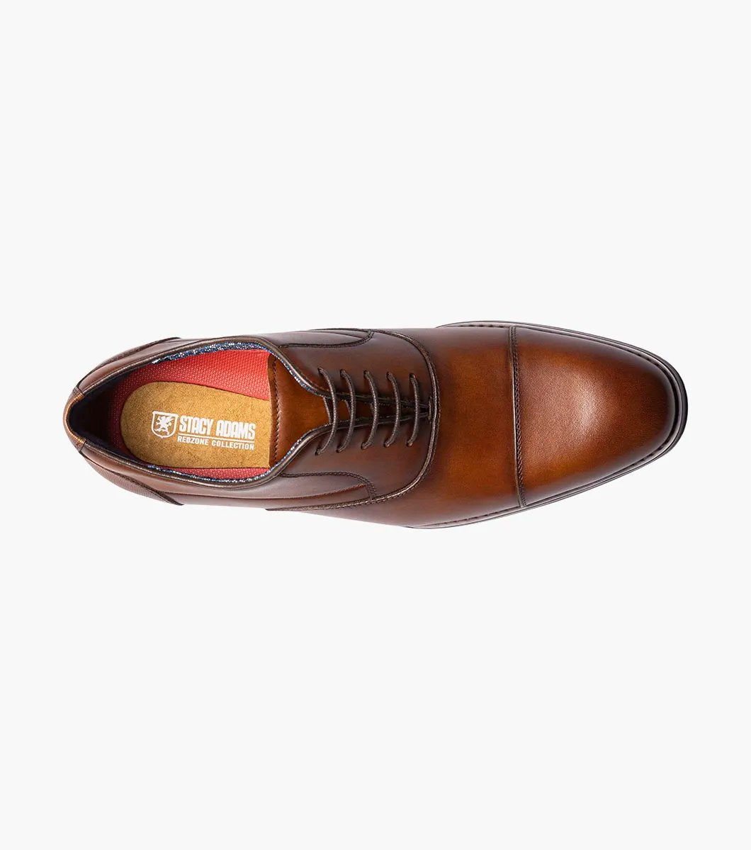 Introducing the Stacy Adams KALLUM Cap Toe Oxford in Cognac, featuring a cap toe and lace-up closure, along with a cushioned footbed for enhanced comfort.