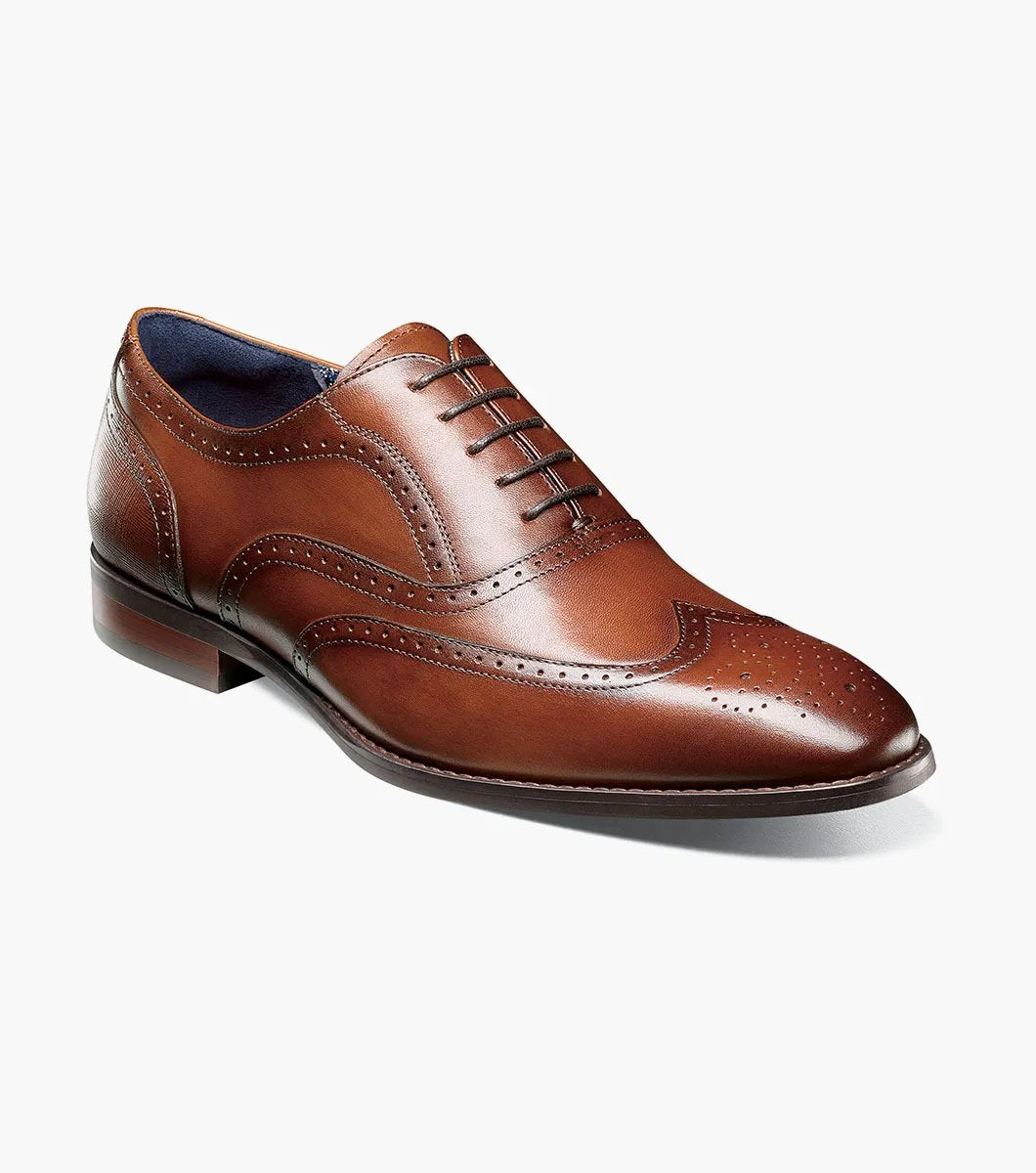 The Stacy Adams KAINE Wingtip Oxford in Cognac, model number 25569-221, from STACY ADAMS, is showcased against a white background, highlighting its intricate stitching and decorative perforations.