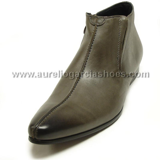 The FI-3101 Grey Encore by Fiesso is a fashion boot made of brown leather, featuring a pointed toe and a side zipper, depicted from a slightly angled perspective. It also includes a cushioned insole for enhanced comfort.