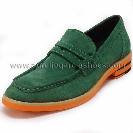 The FI-6703 Green Fiesso By Aurelio Garcia, a slip-on loafer by Fiesso, features green suede with an eye-catching orange sole and a penny slot on the upper for a blend of fashion and comfort, prominently showcased against a white background.