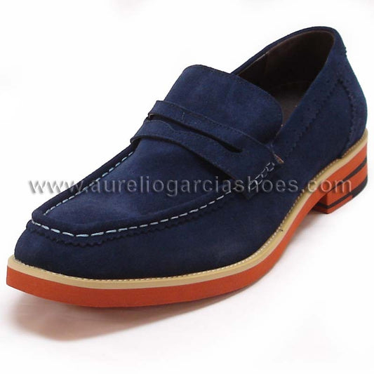 The FI-6703 Navy Fiesso By Aurelio Garcia men's casual leather shoe from Fiesso showcases a navy suede upper and penny strap, accented by a contrasting orange sole and equipped with a cushioned insole for enhanced comfort.