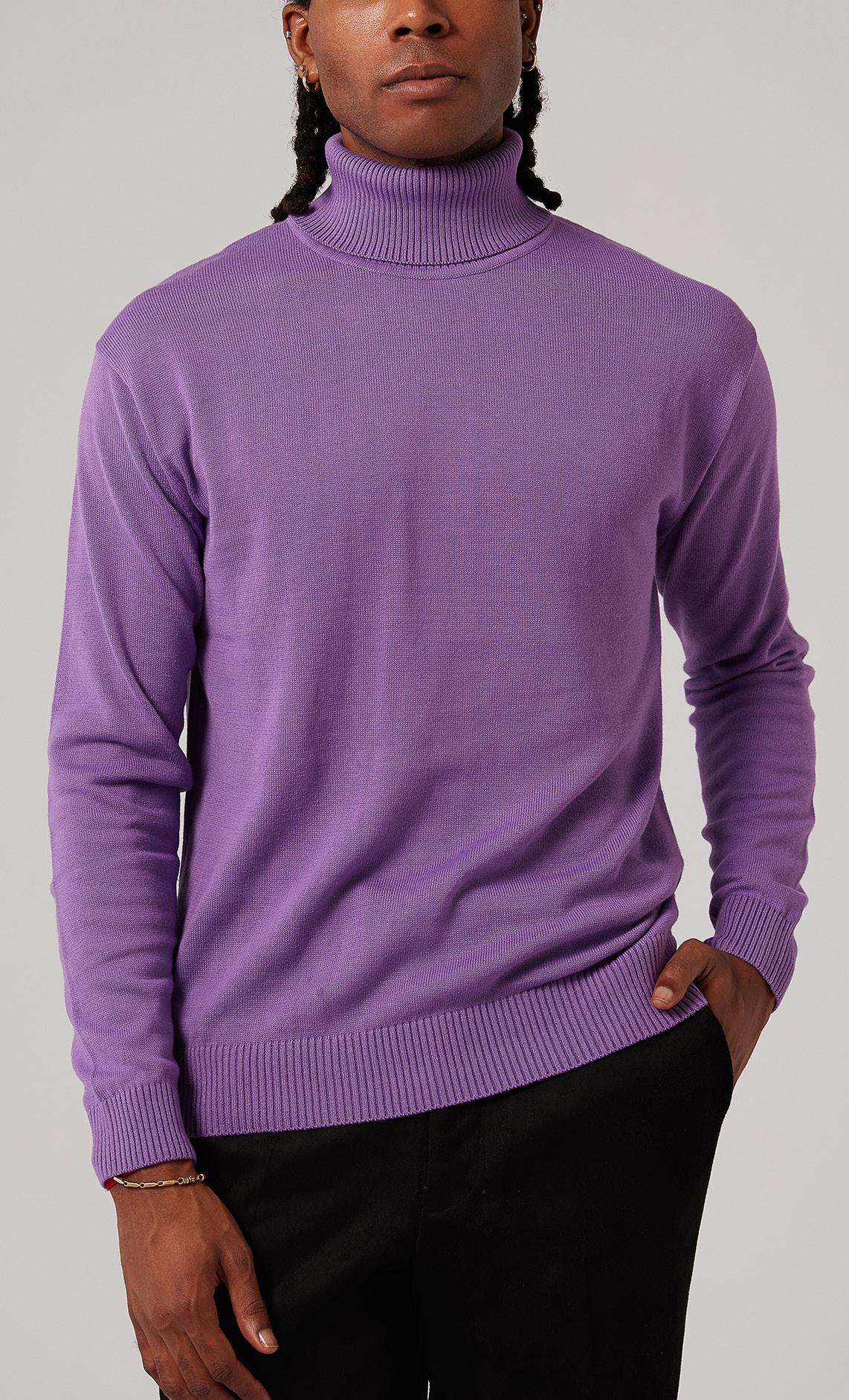 An individual dressed in an Inserch Cotton Blend Slim Fit Turtleneck Sweater in purple, paired with black pants, poses against a plain backdrop to highlight the sweater's anti-pilling feature for enduring elegance.