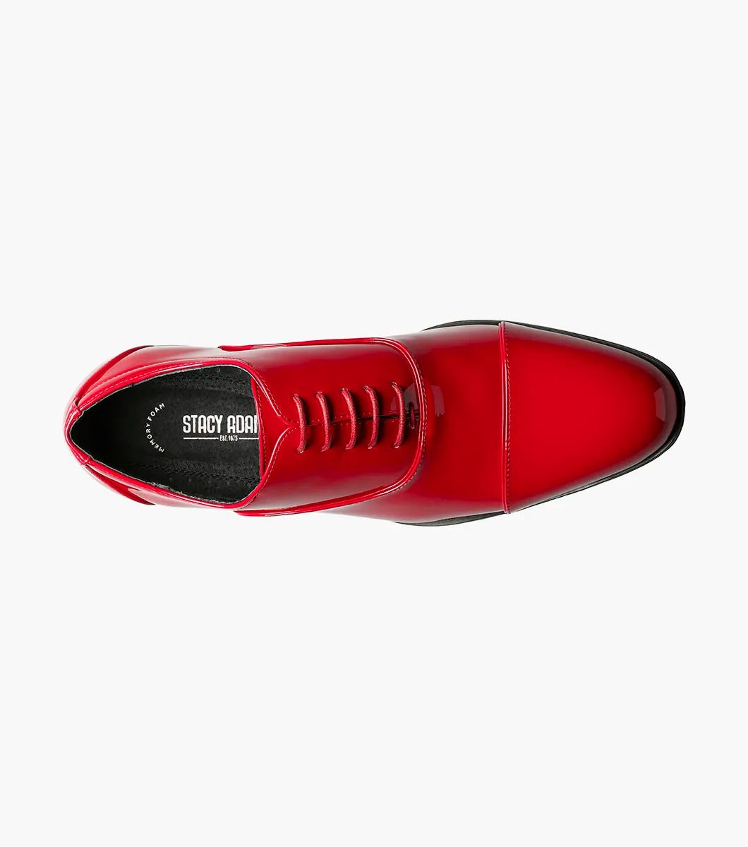 A solitary Stacy Adams GALA Cap Toe Oxford, product number 24998-600, made of shiny red patent leather with black soles and a closed lacing system featuring a memory foam insole, is displayed against a plain white background.