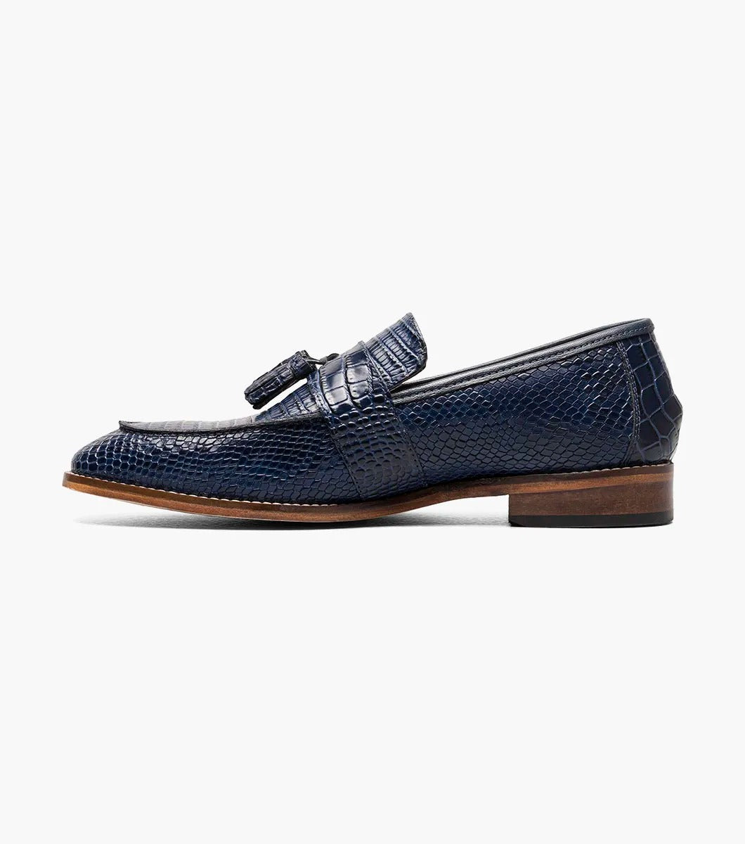 The Stacy Adams PACETTI Leather Sole Moc Toe Tassel Slip On in blue features a textured design with a memory foam insole and a brown sole.