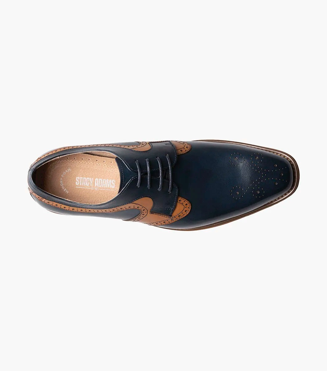 A side view of the Stacy Adams - PALMER Plain Toe Medallion Oxford showcases its navy and brown leather design, complete with decorative perforations and a wooden heel.