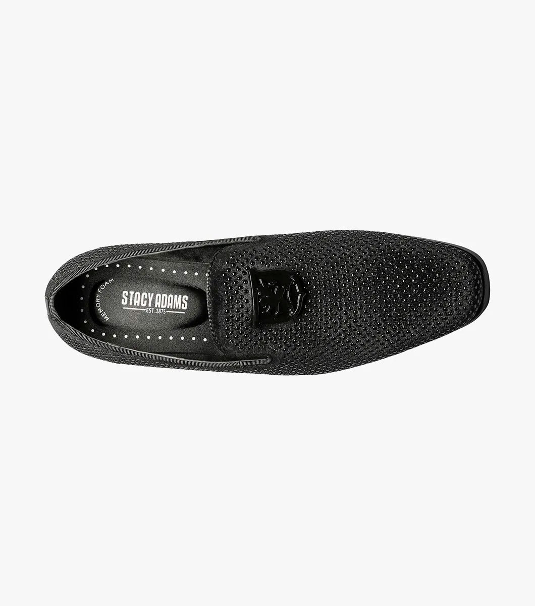 The Stacy Adams - SWAGGER Studded Slip On in black (style 25228-001) features a striking silver emblem, accompanied by a textured design and low heel. These shoes offer a sophisticated touch with the added comfort of memory foam, making them ideal for any occasion.