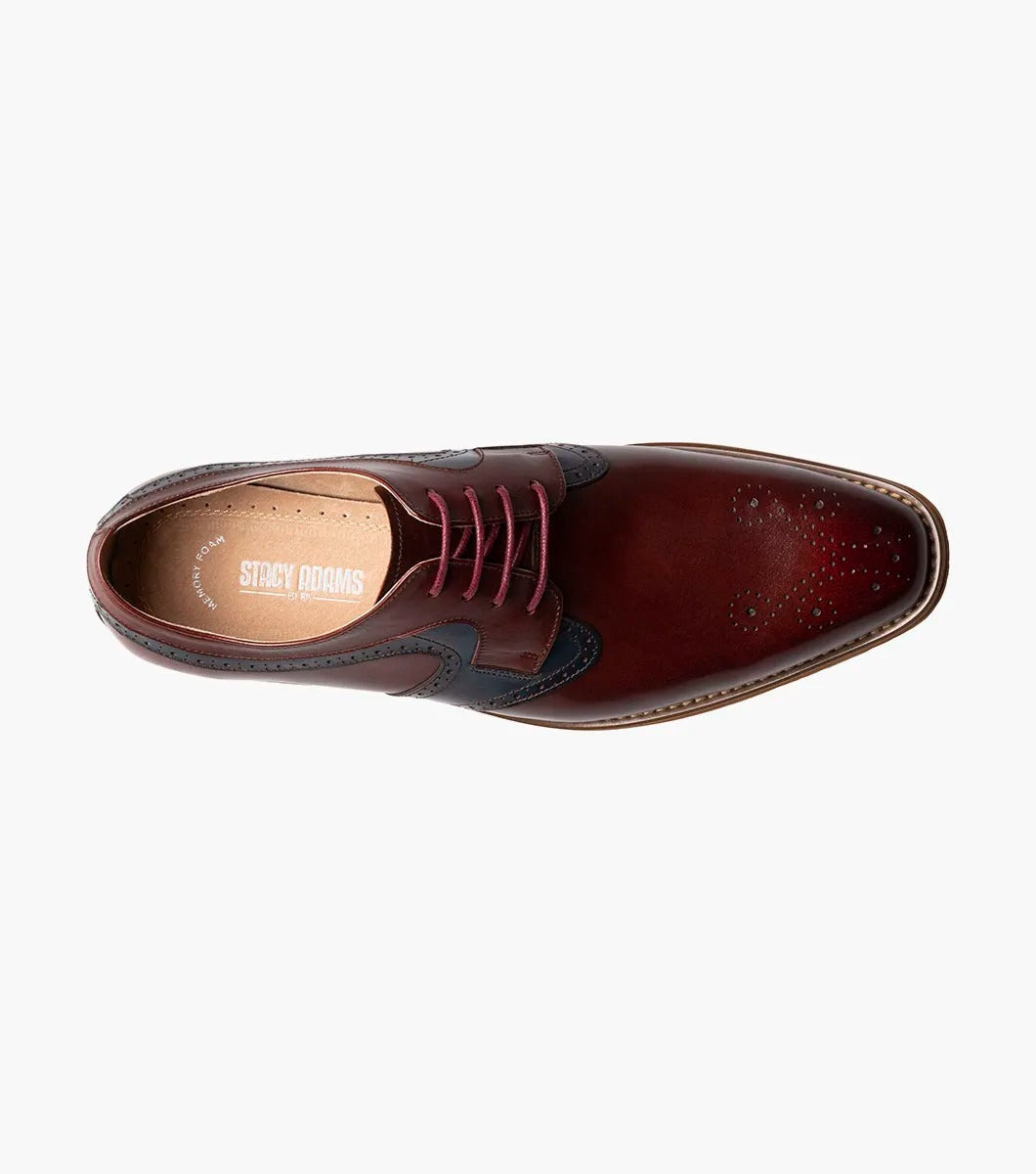 The STACY ADAMS Palmer Plain Toe Medallion Oxford in Burgundy Multi is an elegant men's dress shoe made from luxurious buffalo leather in burgundy and navy, featuring detailed perforations and a traditional wooden sole.