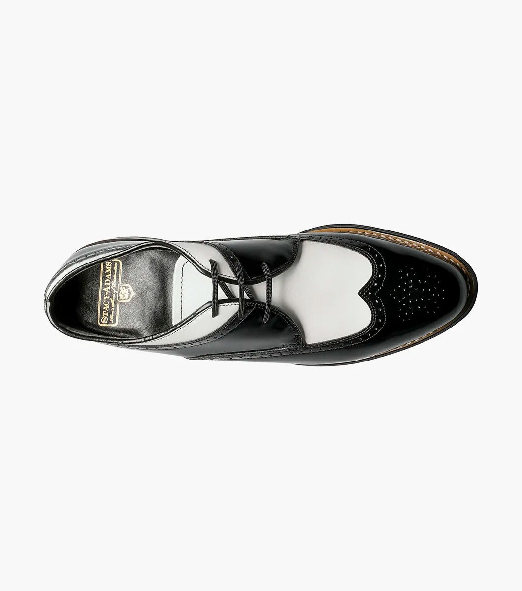 The Stacy Adams - DAYTON Snakeskin Wingtip Oxford in black and white is a sophisticated shoe from STACY ADAMS, expertly crafted from premium patent leather. It features a lace-up closure and classic Goodyear welt construction, set against a plain background.