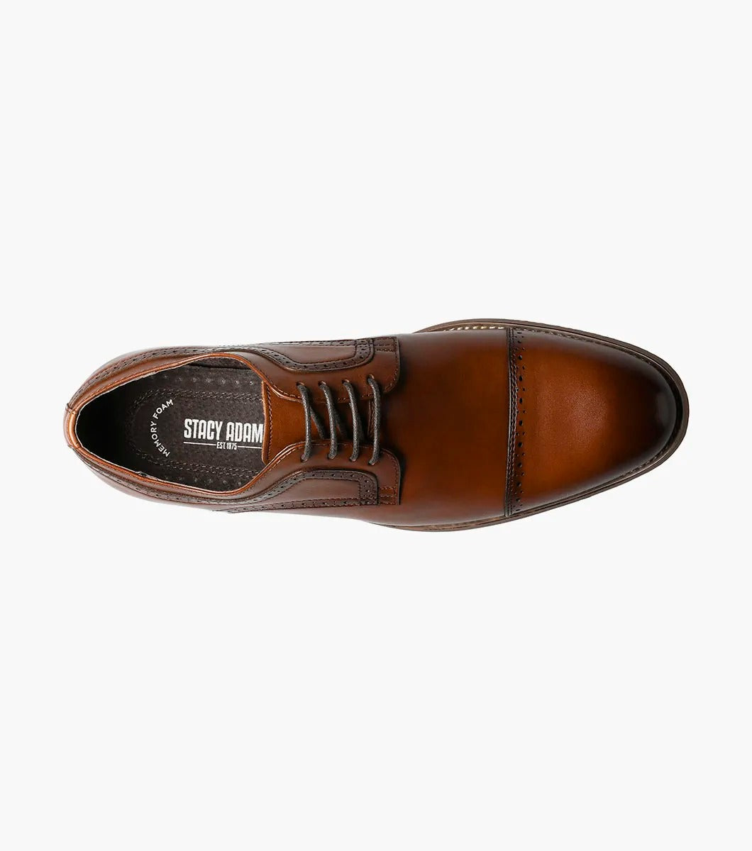 The Stacy Adams - DICKINSON Cap Toe Oxford in Cognac (25066-221) showcases a Leather Upper with decorative perforations, lace-up closure, and Memory Foam for enhanced comfort, all displayed on a white background.