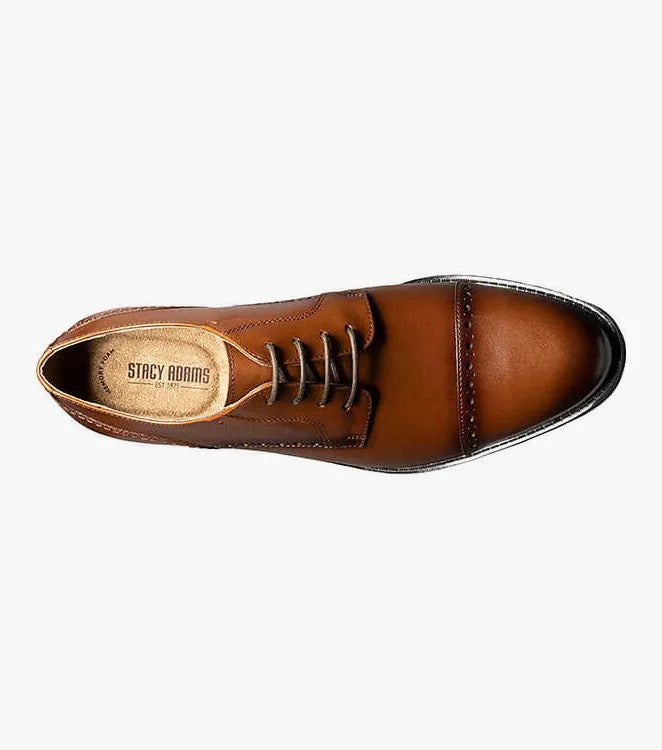 The Stacy Adams BARNETT Cap Toe Oxford in Scotch color, model 20196-232, is a classic brown burnished leather dress shoe with decorative stitching and laces. It features a low heel, smooth sole, and embodies the timeless elegance of a Cap Toe Oxford.