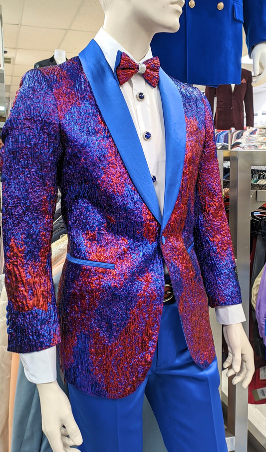 A mannequin in a clothing store showcases the INSOMNIA Super Slim Blazer 4 by Insomnia, featuring a shiny, textured blue and red design with blue lapels, paired with a white shirt, blue pants, and a coordinating blue and red bow tie.