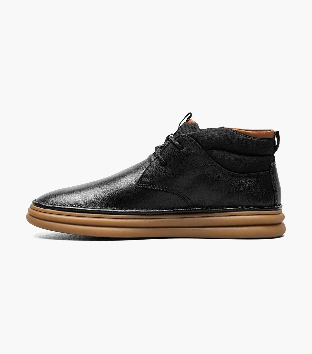 The Stacy Adams DELSON Plain Toe Chukka Boot in black features an ankle-high design with a brown rubber sole, a lace-up closure, and added arch support for comfort.