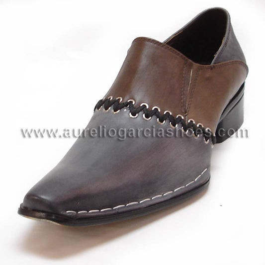 The FI-6708 Black Fiesso by Aurelio Garcia is a high-fashion leather slip-on shoe featuring decorative stitching, a low heel, and a cushioned insole, displayed against a white background.