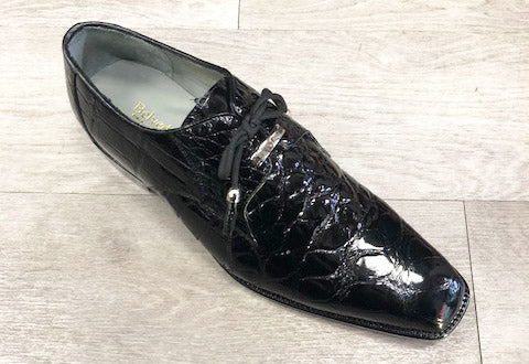 A single Belvedere Lago 14010 Black shoe, made from black patent leather and adorned with tassel laces, rests elegantly on a light-colored floor.