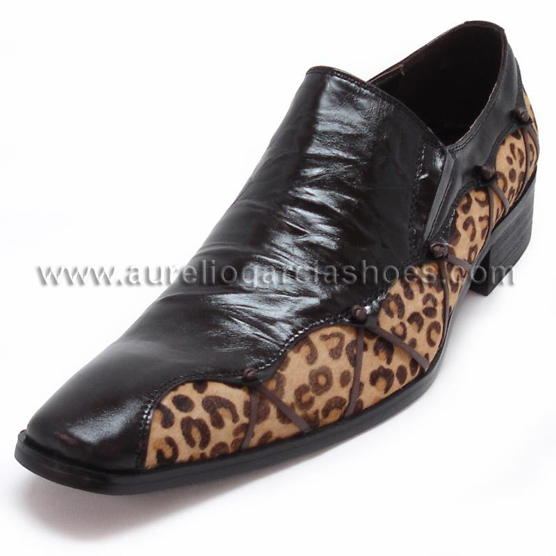 The FI-6676 Black Fiesso by Aurelio Garcia, a product from the brand Fiesso, is a stylish black leather shoe with leopard print accents, featuring a pointed toe design and a cushioned insole for enhanced comfort.