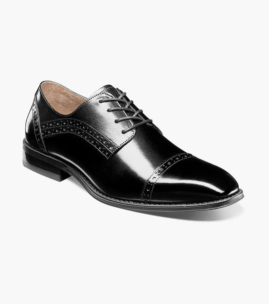 The Stacy Adams - GARRETT Cap Toe Oxford in black, product code 25543-001, is a polished Buffalo leather dress shoe with laces, decorative perforations, and a low heel.