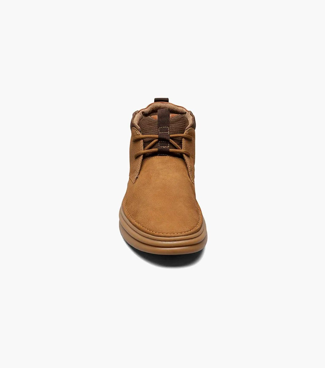 The Stacy Adams DELSON Plain Toe Chukka Boot in camel features a sleek brown suede leather upper with matching laces and a tan rubber sole, showcased from a frontal perspective.