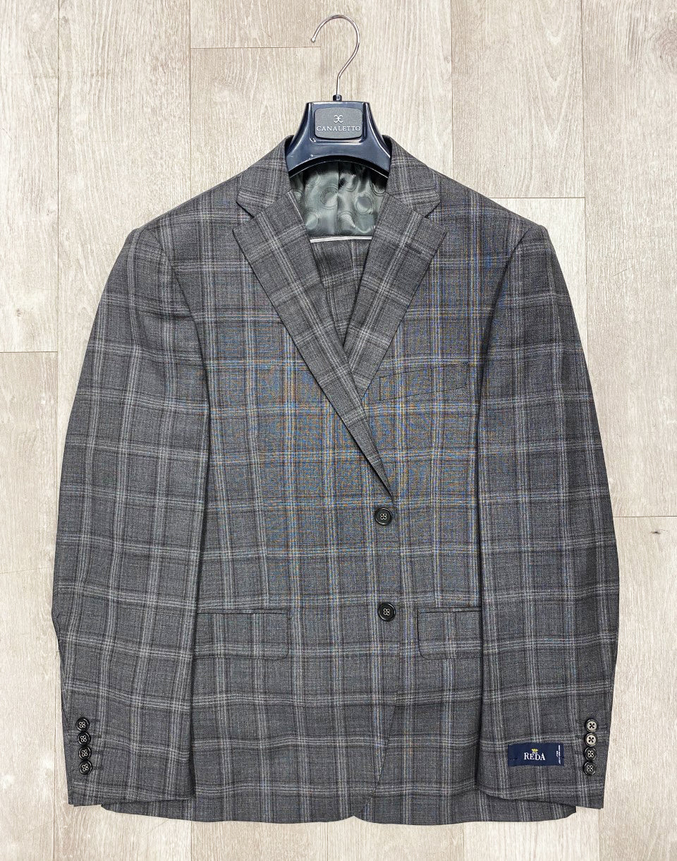 The Canaletto Grey/Plum Plaid Dolcetto Modern Fit Pure Wool Suit by Reda Cloth is elegantly crafted and displayed on a wooden hanger against a light wooden background.