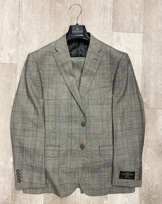 The Canaletto Grey Plaid Dolcetto Modern Fit Pure Wool Suit by Vitale Barberis Canonico Cloth, expertly showcased on a wooden hanger against a light wood floor background, is available in sizes 46S and 38R.