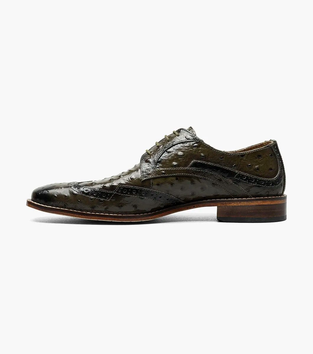 The Stacy Adams GENNARO Wingtip Oxford in olive (25537-303) is a refined shoe crafted from ostrich quill print leather, showcasing a textured pattern with brogue detailing, and includes a RedZone removable footbed for enhanced comfort.