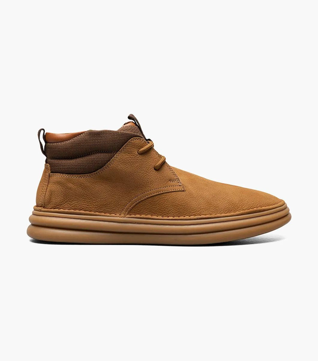 The Stacy Adams DELSON Plain Toe Chukka Boot in Camel (model 25556-228) has a durable rubber sole and lace-up front, offering anatomical arch support for all-day comfort against the crisp white background.