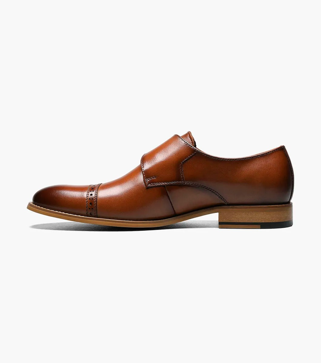 The Stacy Adams DESMOND Cap Toe Monk Strap in cognac combines a buckle, decorative perforations, cap toe detailing, and a wooden heel for a sophisticated look.