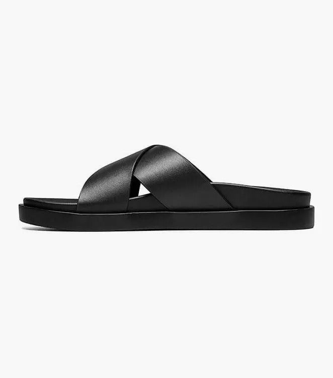 The STACY ADAMS - MONTEL Cross Strap Slide Sandal in Black (Product Number: 25469-001) showcases a sleek design featuring crisscross straps and a comfortable flat sole, complete with a cushioned insole for all-day support.