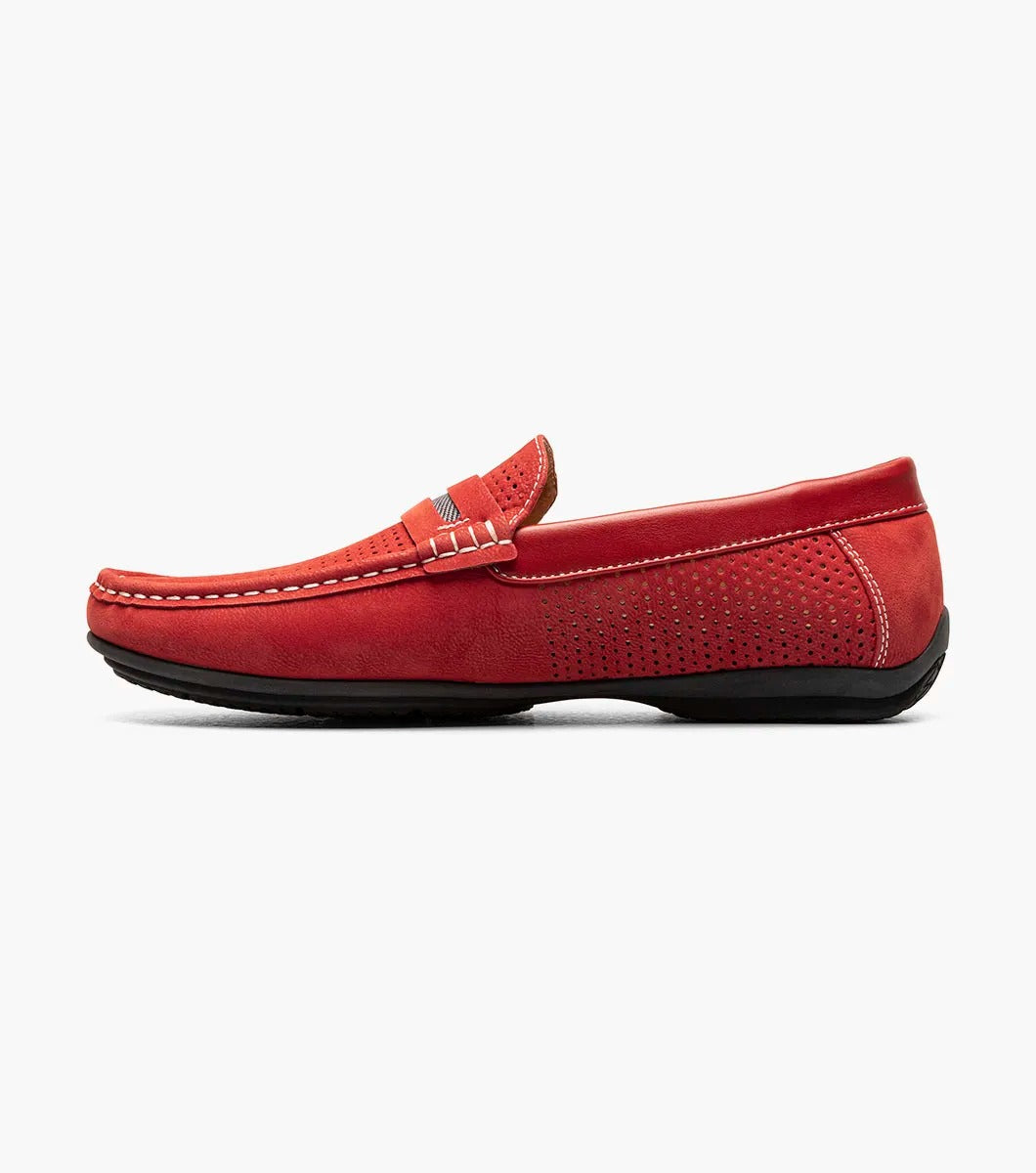 Introducing the Stacy Adams - CORBY Moc Toe Saddle Slip On in Red (25513-600). This shoe features a red leather loafer design with a perforated upper, complemented by black and red stripe detailing on top. It also boasts a durable rubber outsole, making it the ideal casual warm-weather shoe with its stylish appearance and comfortable fit from STACY ADAMS.