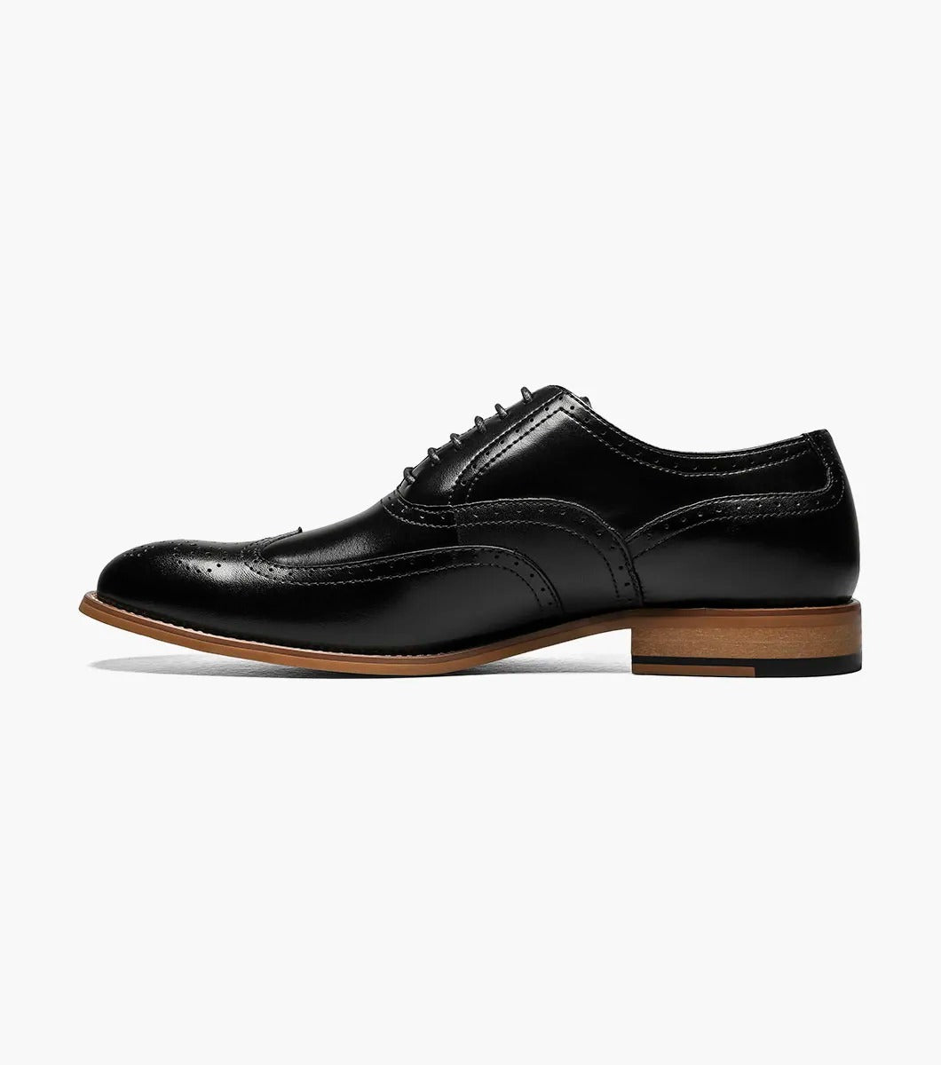 The Stacy Adams DUNBAR Wingtip Oxford in black features decorative perforations, a tan sole, and a comfortable memory foam insole.