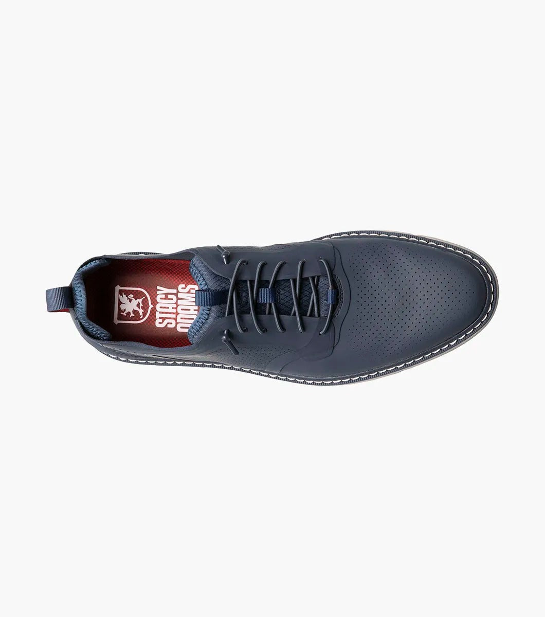 The Stacy Adams SYNCHRO Plain Toe Elastic Lace Up shoe in navy boasts a perforated pattern and a red pull tab, complemented by a light gray sole. It is designed with the RedZone removable footbed to provide anatomical arch support.