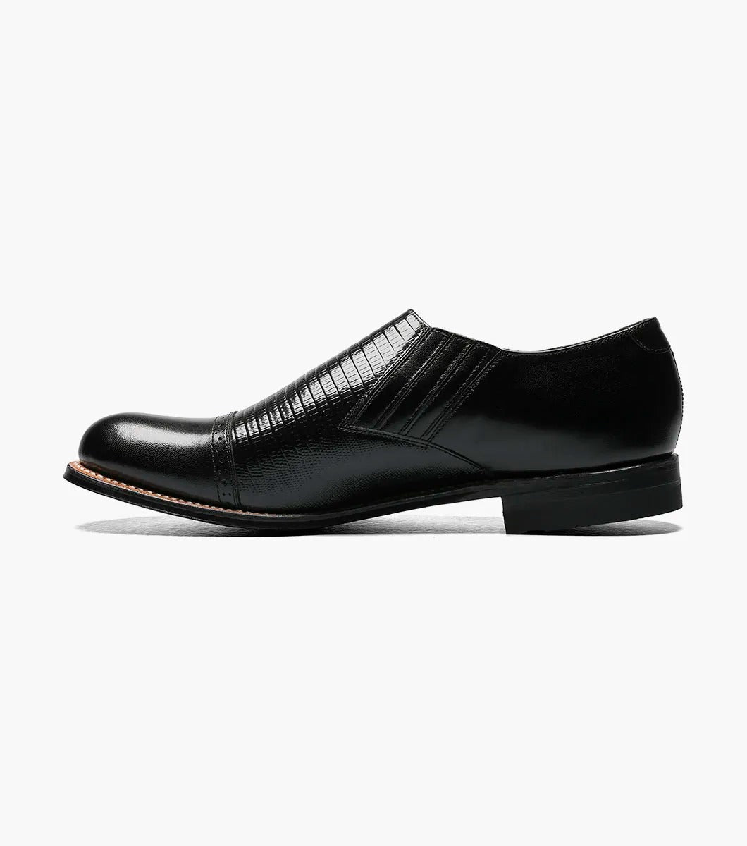 Stacy Adams' MADISON Cap Toe Slip On in black, model 00067-001, is crafted from premium kidskin leather and features textured detailing with a glossy finish.