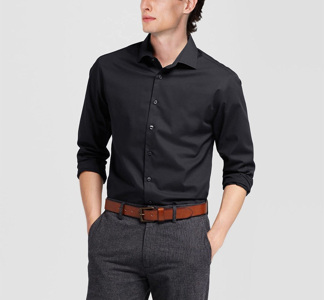 The Renoir VERNO Black Classic/Regular Fit Long Sleeve Spread Collar Dress Shirt TC22 is neatly folded, showcasing its classic fit and spread collar, with a close-up circle highlighting the fabric texture.