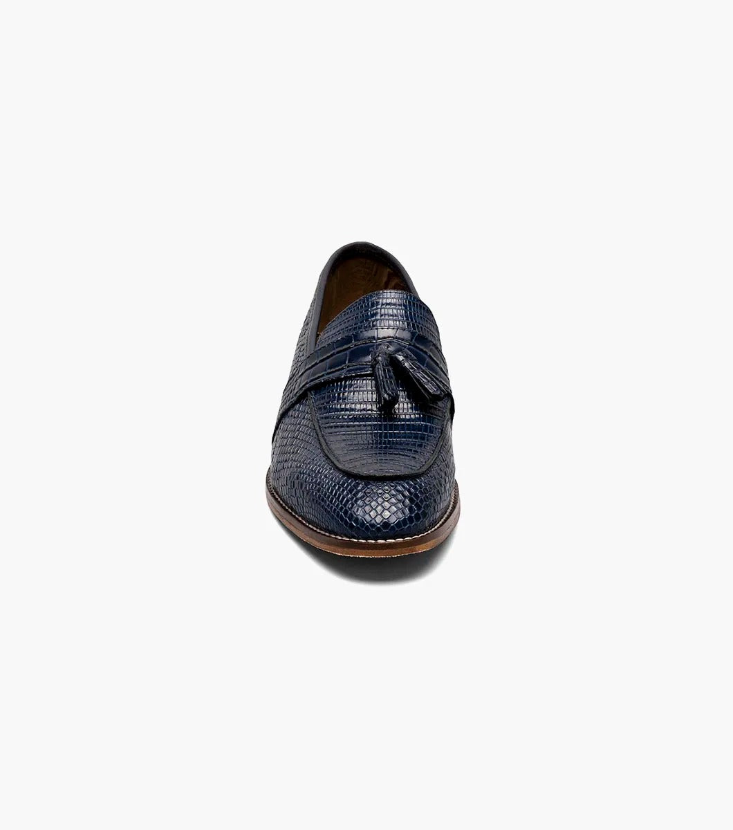 The Stacy Adams PACETTI Leather Sole Moc Toe Tassel Slip On in blue features a textured design with a memory foam insole and a brown sole.