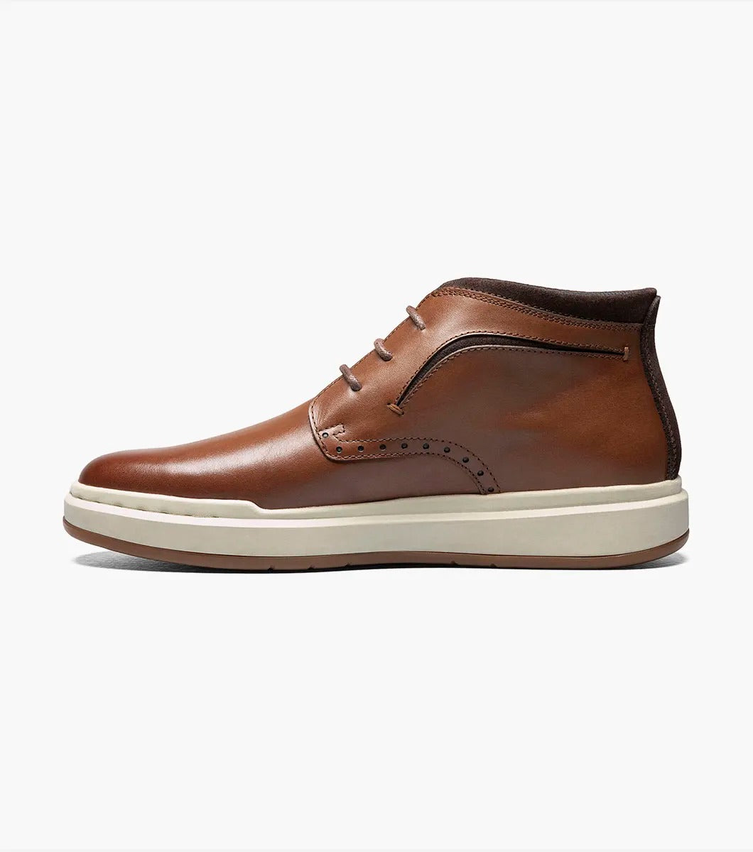 Stacy Adams' CORBIN Plain Toe Chukka Boot features a cognac smooth finish with decorative perforations, a comfortable insole, white sole, and brown laces displayed on a plain white background.