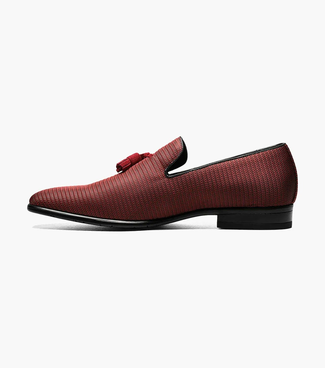 Introducing the Stacy Adams - Tazewell Plain Toe Tassel Slip On in Brick, characterized by its red textured design, black trim, and tassels on top. It features a fully cushioned footbed for ultimate comfort.