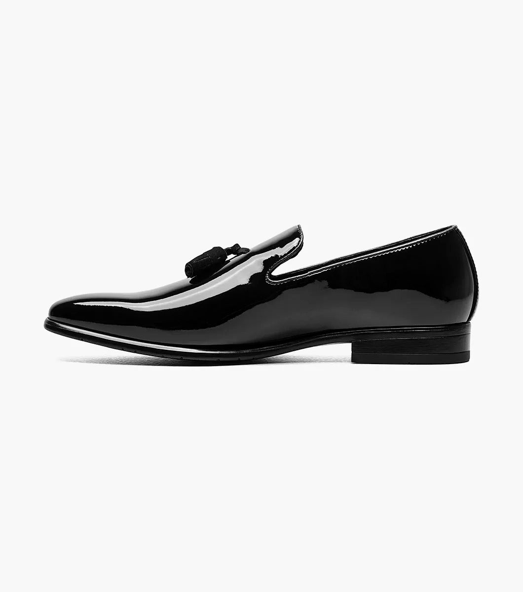 The Stacy Adams PHOENIX Plain Toe Tassel Slip On (Black Patent - 21011-004) is a stylish black loafer crafted with a polished patent upper and low heel, enhanced by a memory foam footbed for superior comfort.