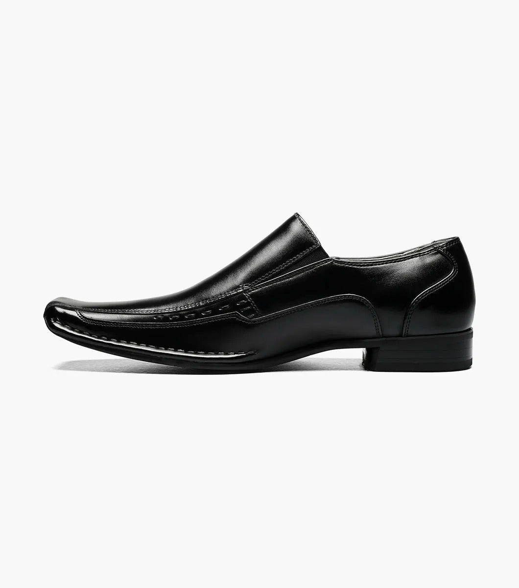 The Stacy Adams - TEMPLIN Bike Toe Loafer in black, designed by STACY ADAMS and identified with model number 24507-001, is a genuine leather shoe boasting a shiny finish and subtle stitching details. It features a cushioned insole for ultimate comfort and is showcased on a plain white background.