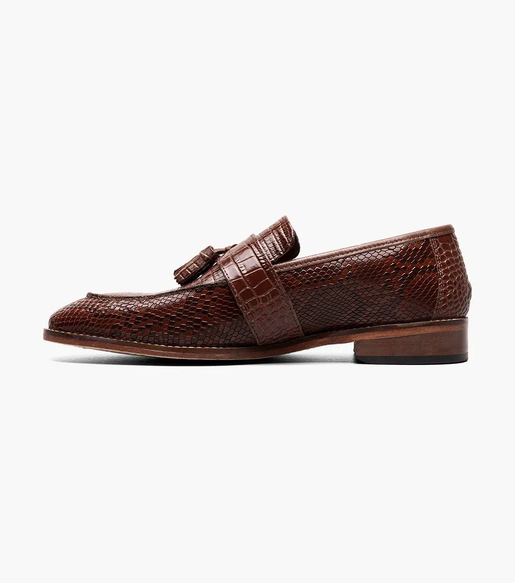 The Stacy Adams - PACETTI Leather Sole Moc Toe Tassel Slip On in Cognac, featuring a textured pattern with tassels on the front and a comfortable memory foam insole, is displayed against a plain white background.