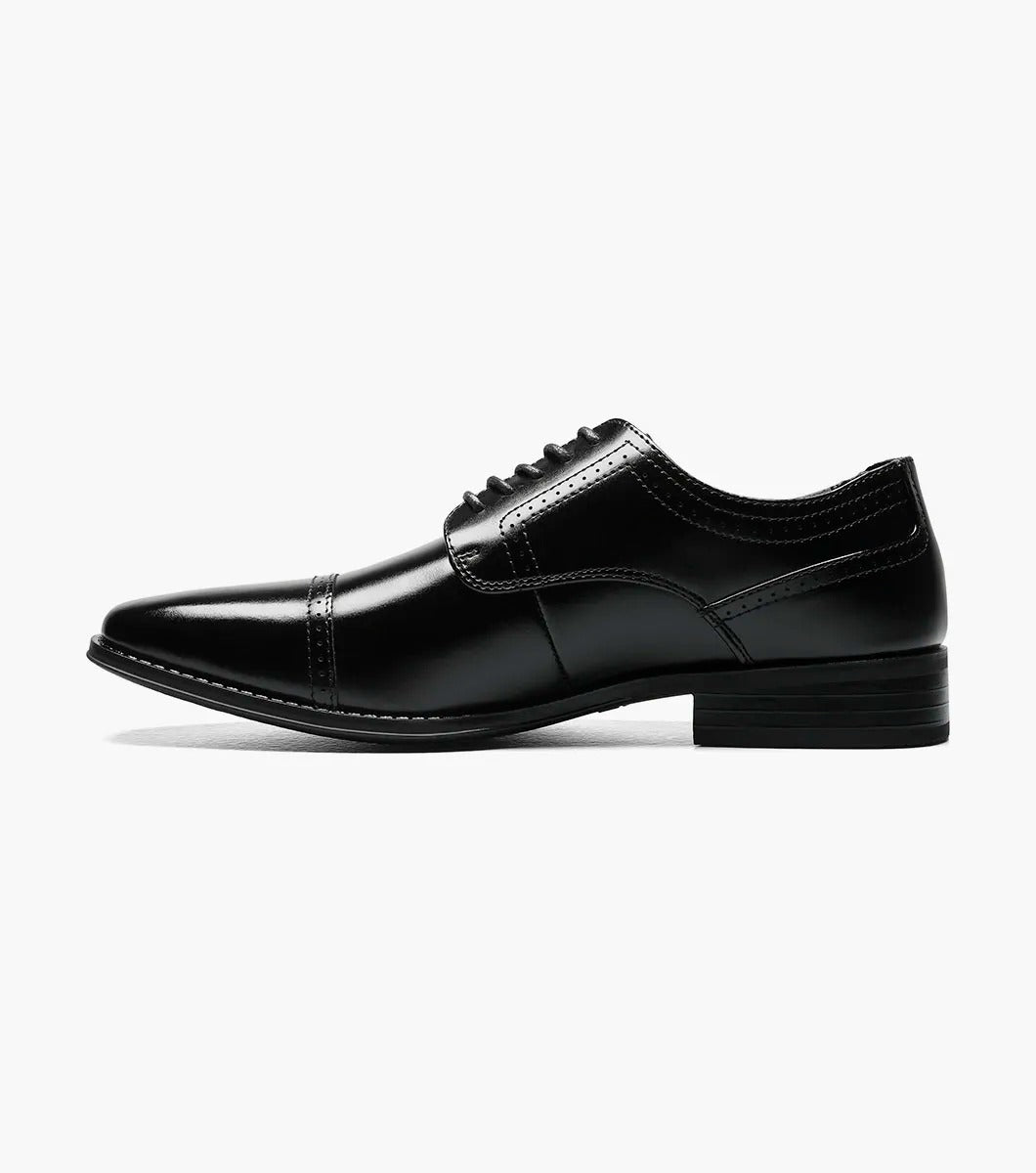 The Stacy Adams WALTHAM Cap Toe Oxford in black (model 20138-001) is a stylish leather dress shoe featuring laces, a sleek cap toe design, and elegant decorative stitching. The low heel and dress style rubber sole ensure modern comfort while maintaining timeless sophistication.