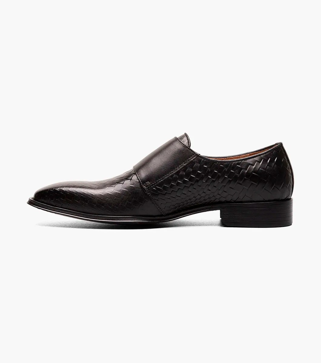 An angled view of the Stacy Adams - TORRANCE Plain Toe Double Monk Strap in Black offers a look at its black woven leather dress design, burnished finish, double monk strap, and low heel.