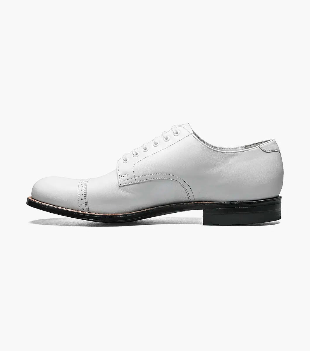 The MADISON Cap Toe Oxford in white, featuring sleek and stylish laces along with a contrasting black sole, embodies the timeless elegance for which STACY ADAMS is renowned.