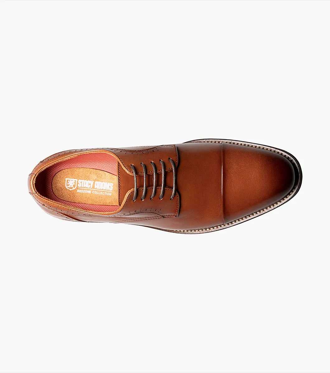 The Stacy Adams MADDOX Cap Toe Oxford in Cognac boasts a burnished leather finish, enhanced with a stylish cap toe and decorative perforations on the sides.