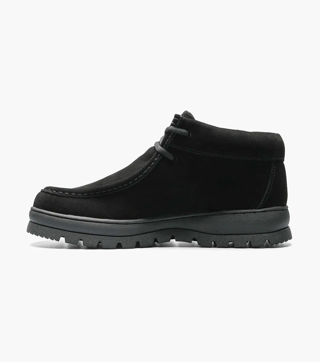 The Stacy Adams - DUBLIN II Moc Toe Boot in black suede, with a thick rubber sole and the signature Moc Toe design, is showcased against a white background.